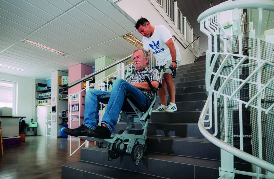 ScalaMobil stair-climbing aid: a passenger is brought safely down the stairs